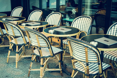 Empty chairs and tables in cafe