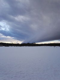 Scenic view of frozen lake against sky during winter