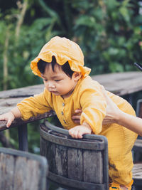 Portrait of boy sitting on bench