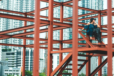 Portrait of young woman on built structure