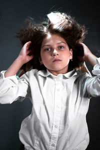 Portrait of a girl wearing mask against black background