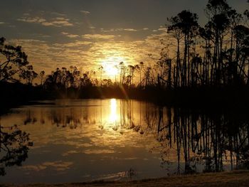 Scenic view of lake against sky during sunset