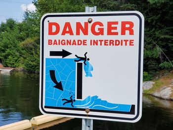 Close-up of road sign against trees