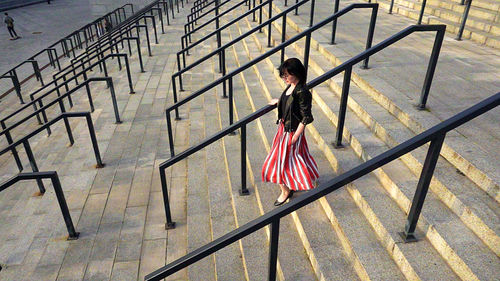 Woman walking on railing