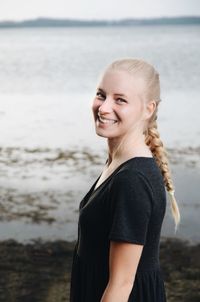 Portrait of a smiling happy young woman on beach