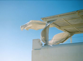 Low angle view of built structure against clear blue sky