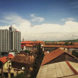 Houses against cloudy sky