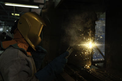 Man working on metal in kitchen