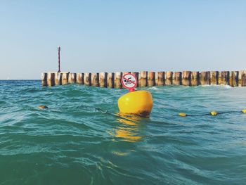 Swimming pool in sea against clear sky