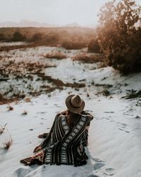 Person sitting in a desert