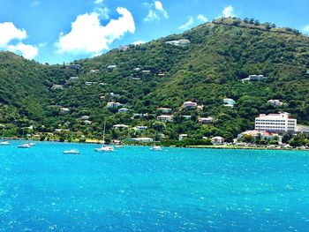 Scenic view of sea and mountains against sky