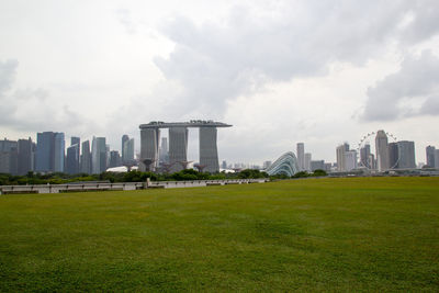 Buildings in city against cloudy sky