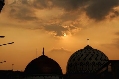 Silhouette cathedral against sky during sunset