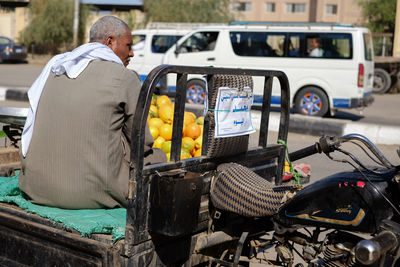 Rear view of man standing on street in city