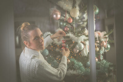 Woman decorating christmas tree