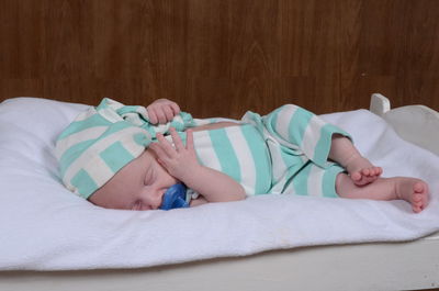 Cute boy lying on bed at home