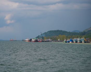 Sailboats in sea against sky