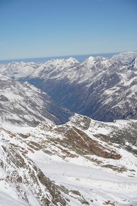 Scenic view of snowcapped mountains against clear sky