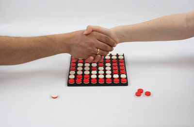 High angle view of people playing on table against white background