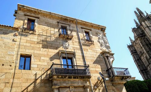 Low angle view of old building against clear blue sky