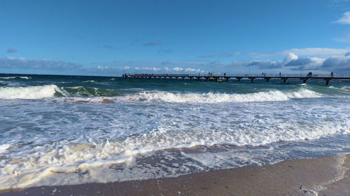 Scenic view of sea against blue sky