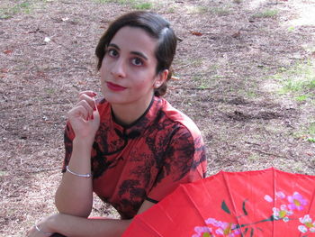 Portrait of young woman sitting outdoors