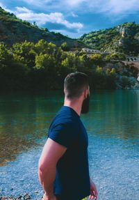 Rear view of man standing in lake