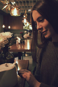 Close-up of woman sitting at table in restaurant