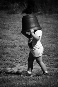 Full length view of boy with bucket on head