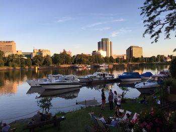 Boats in river with city in background