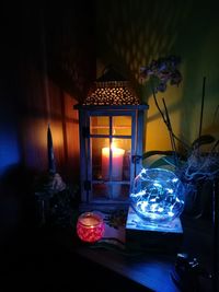 Close-up of illuminated lamp on table