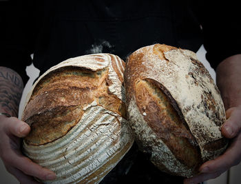 Midsection of man holding bread