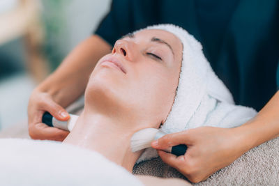 Close-up of woman getting massage therapy at spa