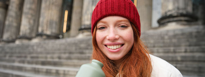 Portrait of young woman wearing hat