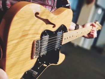 Close-up of man playing guitar