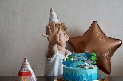 Midsection of boy holding table at home