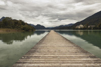 Pier over lake against sky