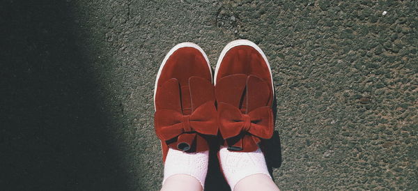 Low section of woman in shoes standing outdoors