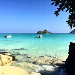 Scenic view of aqua blue sea against clear sky