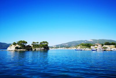 Scenic view of seascape against clear blue sky