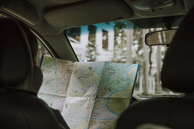 Person holding map in car 