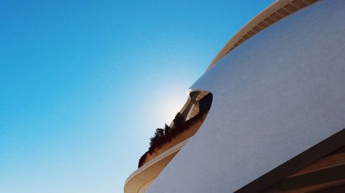 Low angle view of hand against clear blue sky