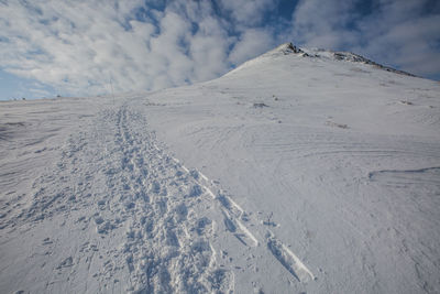 Scenic view of snowcapped mountains against sky