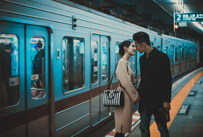 Couple embracing at subway station