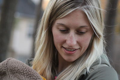 Close-up portrait of smiling young woman