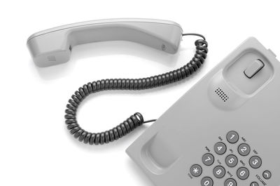 High angle view of landline phone on white background