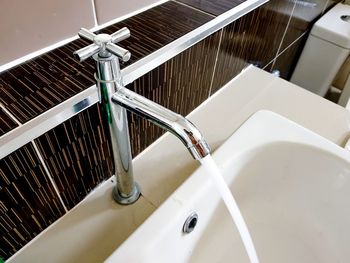 High angle view of water flowing from faucet in sink