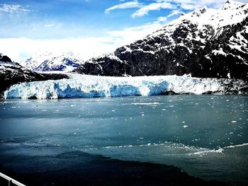 Frozen lake against mountain during winter