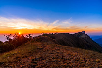 Scenic view of field against sky during sunset