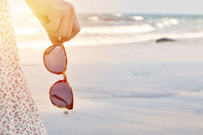 Close-up of sunglasses on beach